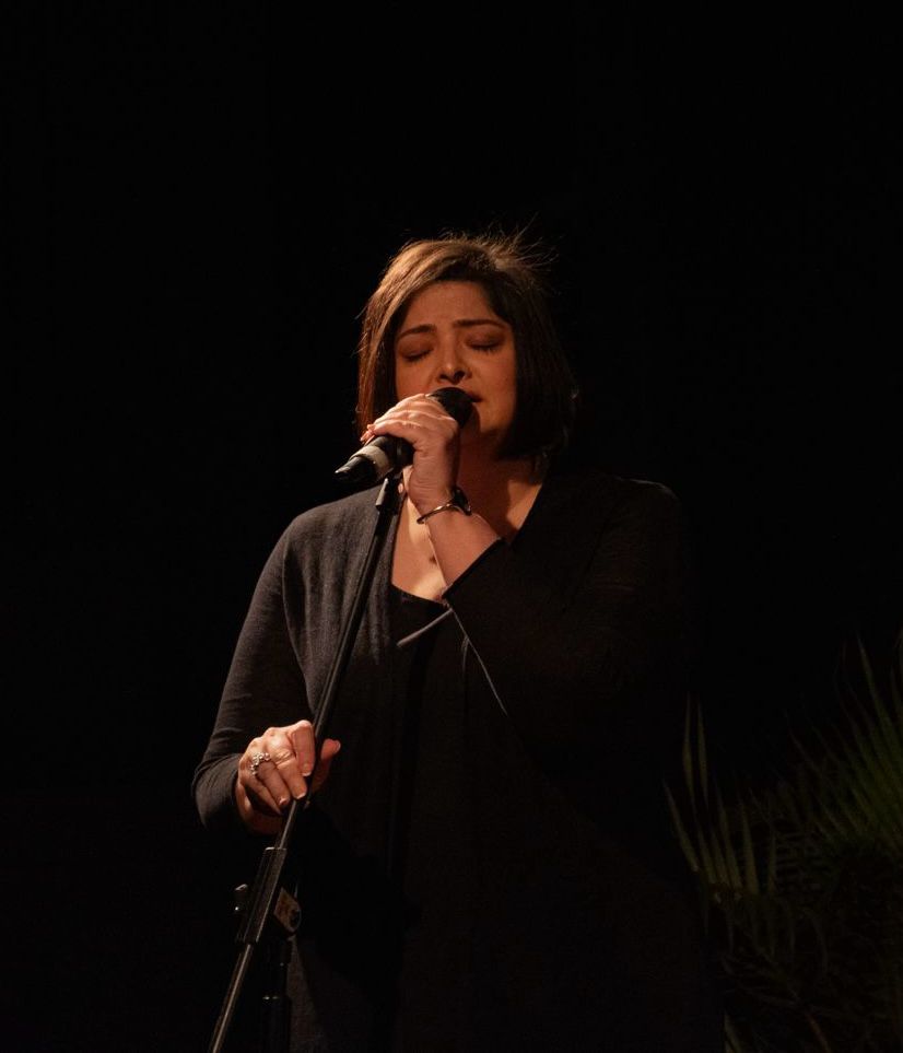 Vasundhara Das in an intimate moment singing into the microphone.