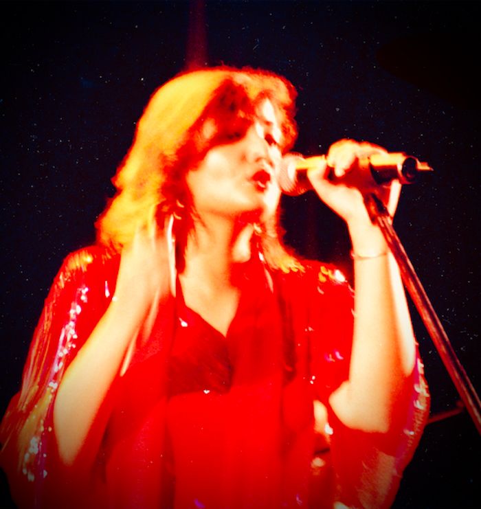Vasundhara Das performing in red, early stage years.